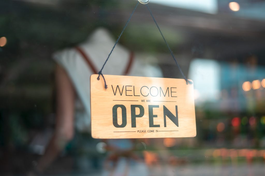 Open sign that reads, "Welcome, We are open. Please come in."
